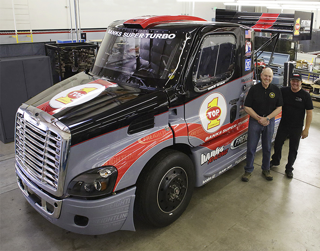 Gale Banks and Mike Ryan stand next to the Freightliner Cascadia Race Truck