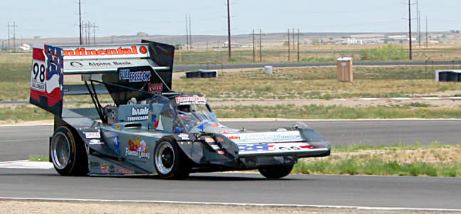 Looking closely at the car as Dallenbach rockets out of the corner on the Pueblo road course you can see that the rear end is solidly planted while the inside front tire is nearly lifted off the ground.